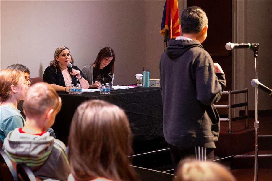 An image of the spelling bee pronouncer Stacey Martin (Assistant Principal at Jacobson Elementary) and Elizabeth Sacco (Assistant Principal at CTA Independence)